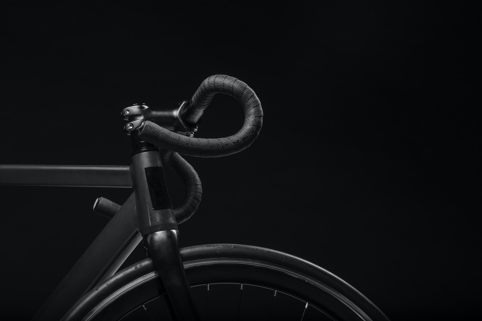 Photo by Josh Nuttall black road bicycle handle with black background