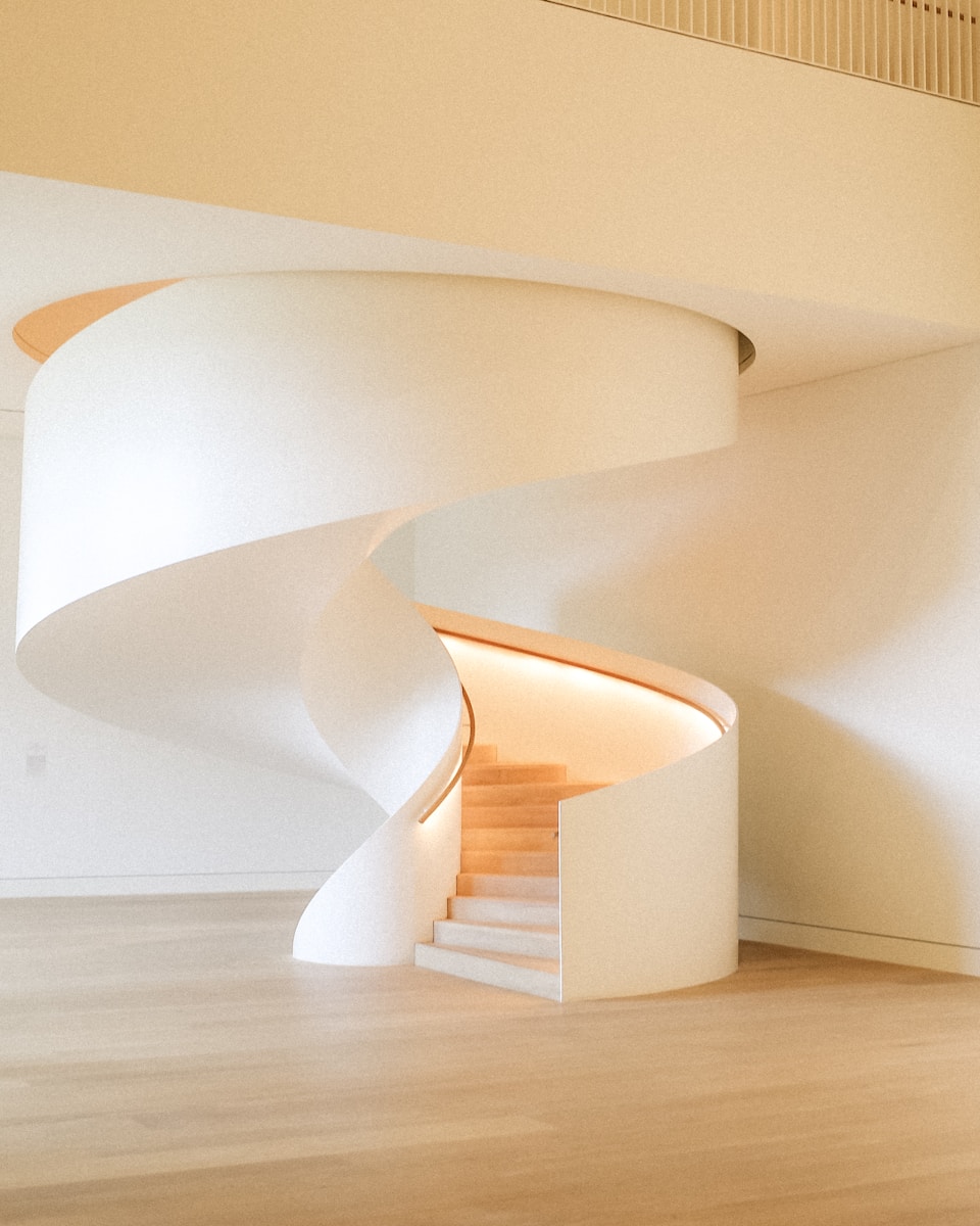 Photo by Minyeong Jeong A modern, white spiral staircase.